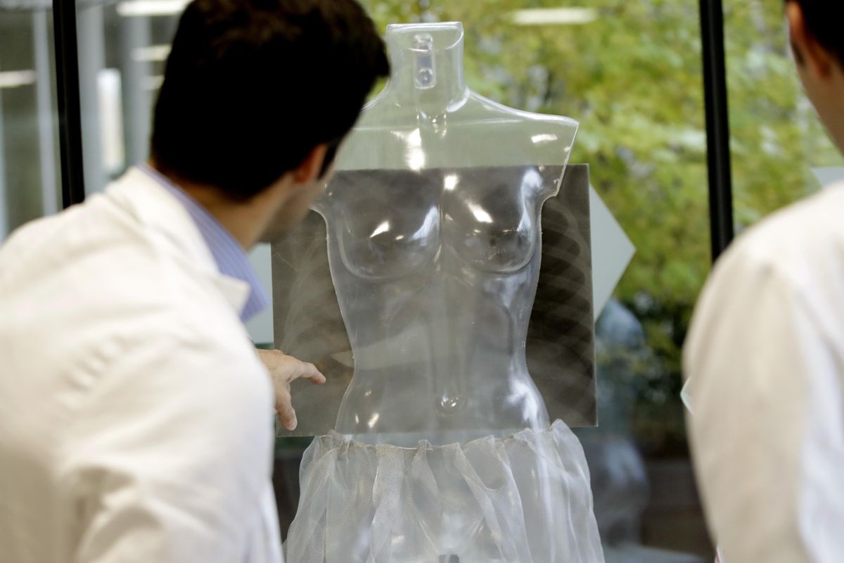 Doctors look at an X-ray showing a woman’s chest pierced by a knife, displayed during the exhibition “Invisibility is not a super power” which includes X-ray’s of anonymous women who arrived at the hospital’s emergency room claiming to be victims of violence, at the San Carlo Hospital, in Milan, Italy, Friday, Nov. 22, 2019. The exhibition, a combination of photographs and X-rays, was promoted on the occasion of the International day for the Elimination of Violence Against Women which takes place on Nov. 25. (Luca Bruno / Associated Press)