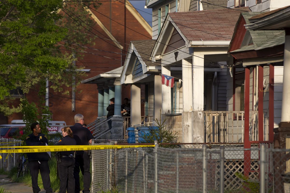 Cleveland police stand outside a home where they say missing women Amanda Berry, Gina DeJesus and Michelle Knight were found in Cleveland on Monday. The three women, who went missing about a decade ago, were found alive in a residential area just south of downtown, and three brothers were arrested. (Associated Press)