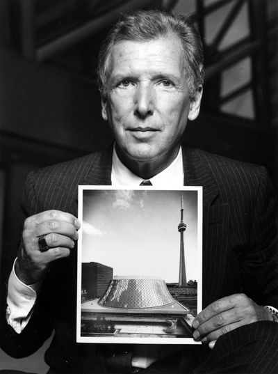 Architect Arthur Erickson is shown in 1982 with a photo of Toronto’s Roy Thompson Hall, which he helped design.  (Associated Press / The Spokesman-Review)