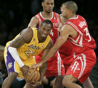 
Houston's Shane Battier, right, pesters Los Angeles' Kobe Bryant in an NBA opener on Tuesday night. Associated Press
 (Associated Press / The Spokesman-Review)