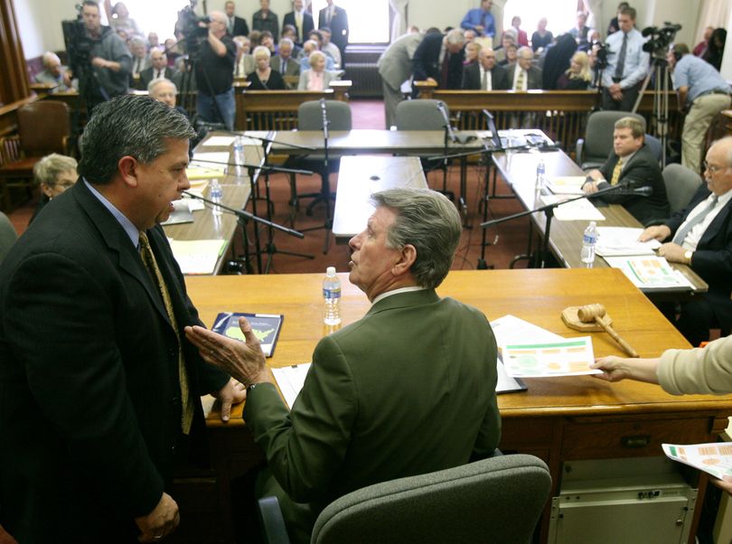 Idaho Gov. Butch Otter, seated, talks to state Superintendent of Public Instruction Tom Luna on Wednesday, Feb. 10, 2010 as the state Land Board considers Luna's request to draw on a reserve fund to benefit public schools in Boise, Idaho. (Joe Jaszewski / The Idaho Statesman)