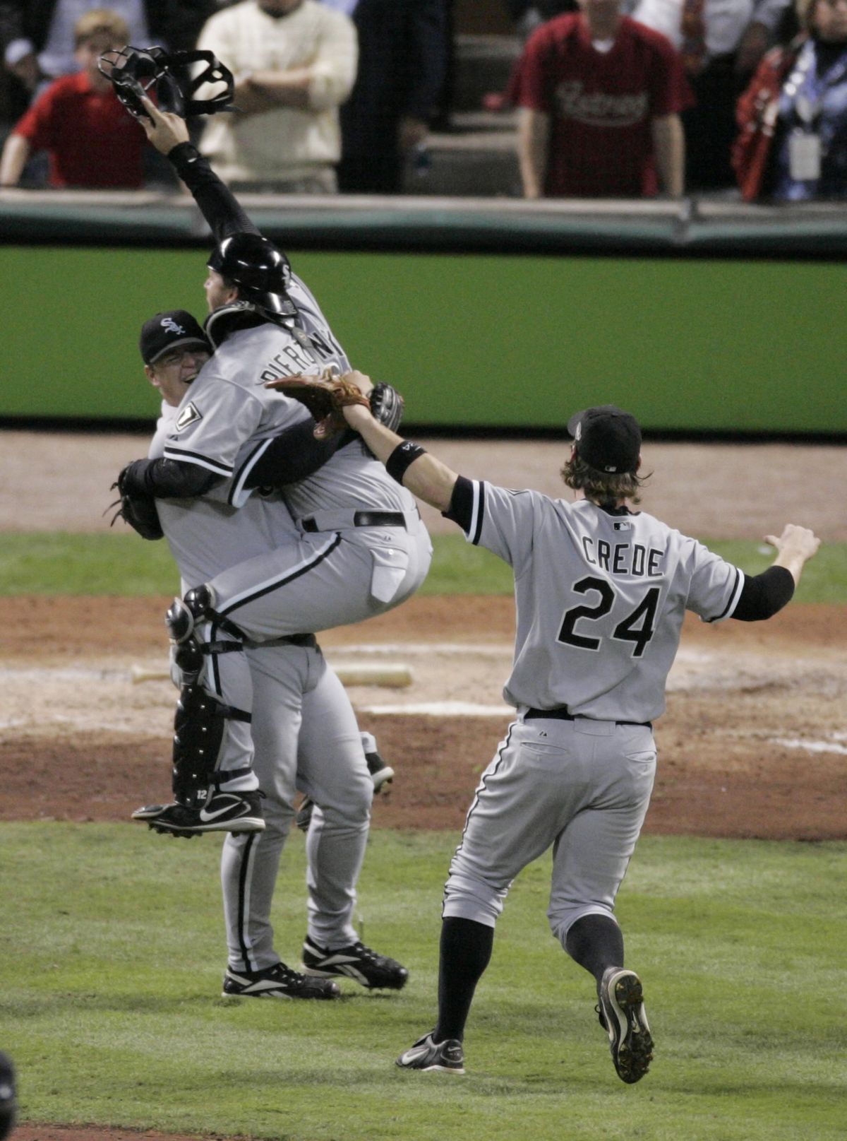 Chicago White Sox catcher A.J. Pierzynski leaps into the arms of reliever Bobby Jenks with teammate Joe Crede coming over to join the celebration as the Sox won Game 4 of the 2005 World Series, sweeping the Houston Astros. (Tribune News Service)