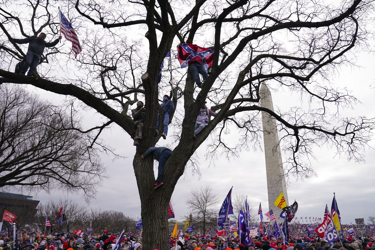 FILE - In this Wednesday, Jan. 6, 2021, file photo, supporters of President Donald Trump participate in a rally in Washington. Both within and outside the walls of the Capitol, banners and symbols of white supremacy and anti-government extremism were displayed as an insurrectionist mob swarmed the U.S. Capitol.  (John Minchillo)