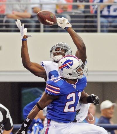 Dallas' Dez Bryant hauls in a 34-yard TD pass behind Buffalo's Leodis McKelvin in the first quarter Sunday. (Associated Press)