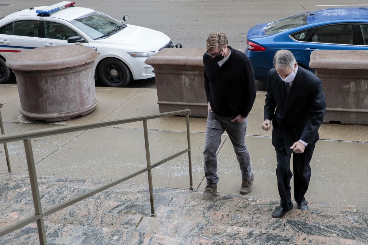 In this Jan. 25, 2021 photo, Dustin Thompson, left, of Columbus, who is accused of being part of the Jan. 6 insurrection at the U.S. Capitol, arrives with his lawyer, Sam Shamansky, to turn himself in at the Joseph P. Kinneary U.S. District Courthouse in Columbus, Ohio.  (Joshua A. Bickel)