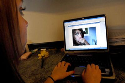 
Andrea Robbins, 13, shows a photo of herself on her MySpace page at home in Hayden recently. Her mother has her password and checks the account regularly. 
 (Kathy Plonka / The Spokesman-Review)