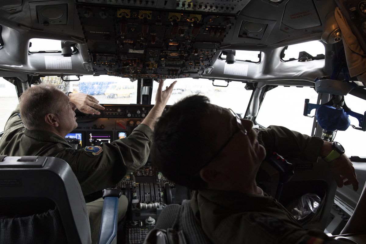 FILE - Pilots work in the cockpit of an AWACS plane at Melsbroek military airport in Melsbroek, Belgium, Wednesday, Nov. 27, 2019. As Russia’s military buildup near Ukraine accelerated early this year, military planners at NATO began preparing to dispatch scores of fighter jets and surveillance aircraft into the skies near Russia and Ukraine. It was a warning to Moscow not to make the mistake of targeting any member country.  (Virginia Mayo)