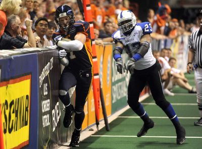 Spokane receiver Andy Olson gets a good shove into the boards from Wilkes-Barre/Scranton’s Chris Royal. (Jesse Tinsley / The Spokesman-Review)
