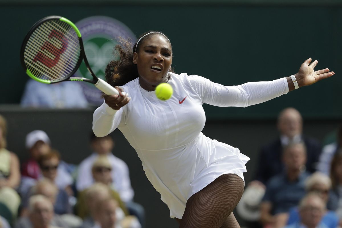 Serena Williams of the United States returns the ball to Italy’s Camila Giorgi during their women’s singles quarterfinals match at the Wimbledon Tennis Championships in London on Tuesday. (Ben Curtis / AP)