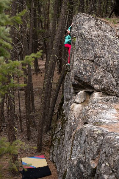 Kristin W. reaches the top of Queen for Queen in the McLellan area, a photo from “Spokane Bouldering: A Comprehensive Guide to the Spokane River Valley.”  (Benjamin Boldt)