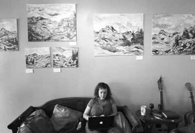 
Karli Fairbanks works on her computer under a display of work by artist David Repyak in the Empyrean Coffee House. 
 (CHRISTOPHER ANDERSON / The Spokesman-Review)