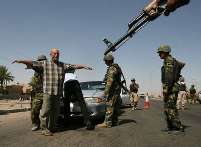 
Iraqi Interior Ministry commandos frisk a motorist and search his car in Baghdad, Iraq, on Wednesday. Prime Minister Nouri al-Maliki's new security crackdown backed up checkpoints. 
 (Associated Press / The Spokesman-Review)