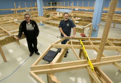 River City Modelers President John Langlot, left, and membership chairman Del Skobalski stand amid the framework for the club’s new model train layout.   (Colin Mulvany / The Spokesman-Review)