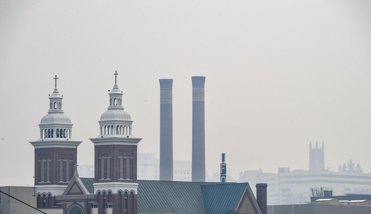 Wildfire smoke shrouds the steeples atop the Cathedral of Our Lady of Lourdes, left, the Steam Plant smoke stacks, the Fox Theater sign, and the Cathedral of St. John the Evangelist, right, on Aug. 2, 2021, in Spokane.  (DAN PELLE/THE SPOKESMAN-REVIEW)