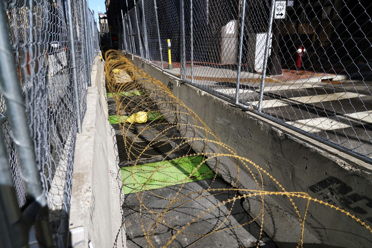 Concertina wire sits between fenced barriers outside the Hennepin County Government Center, Wednesday, Feb. 23, 2021, in Minneapolis, as part of security in preparation for the trial of former Minneapolis police officer Derek Chauvin. The trial is slated begin with jury selection on March 8. Chauvin is charged with murder the death of George Floyd during an arrest last May in Minneapolis.  (Jim Mone)