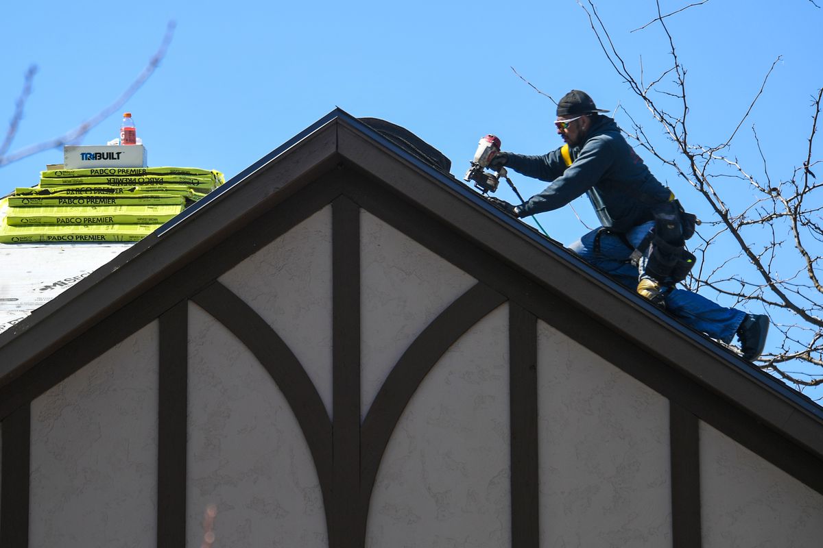 Luigi Aldana, of Stay Dry Solutions, roofs a house on Upper Terrace Road, Tuesday, April 6, 2021 in Spokane.  (Dan Pelle/THESPOKESMAN-REVIEW)