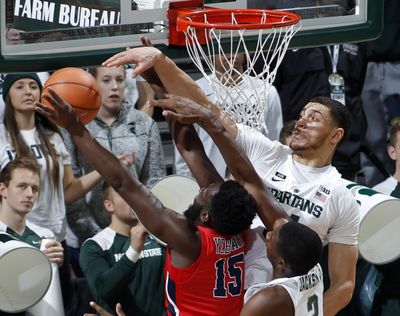 Michigan State's Gavin Schilling, right, blocks a shot by Stony Brook's Akwasi Yeboah (15) during the first half of an NCAA college basketball game, Sunday, Nov. 19, 2017, in East Lansing, Mich. (Al Goldis / Associated Press)