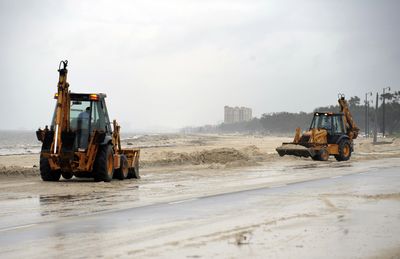 State workers clear sand from U.S. Highway 90 in Biloxi, Miss., last week after Hurricane Gustav.  (Associated Press / The Spokesman-Review)