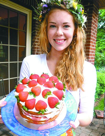 Britta Monson serves her strawberry cake at her family's outdoor party.