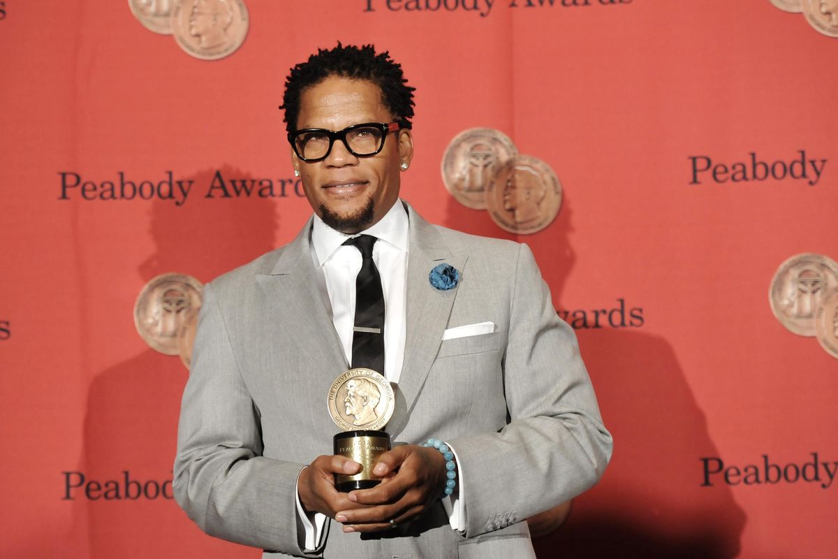 Writer, actor and producer D.L. Hughley poses with his award at the 72nd Annual George Foster Peabody Awards at the Waldorf-Astoria in 2013 in New York. (Evan Agostini / Evan Agostini/Invision/AP)