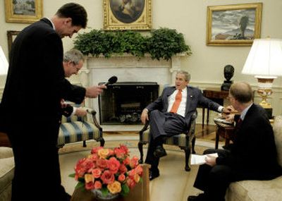 President Bush meets with reporters, from left, Richard Keil of Bloomberg, Terence Hunt of the Associated Press and Steve Holland of Reuters in the Oval Office on Wednesday. 
 (Associated Press / The Spokesman-Review)