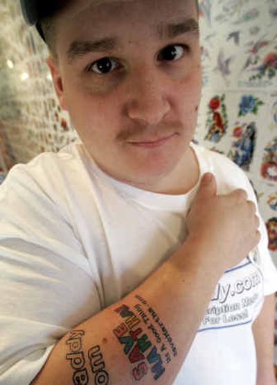 
Joe Tamargo, 31, has started a new enterprise, selling advertisers the opportunity to permanently tattoo their messages on his body. 
 (Associated Press / The Spokesman-Review)
