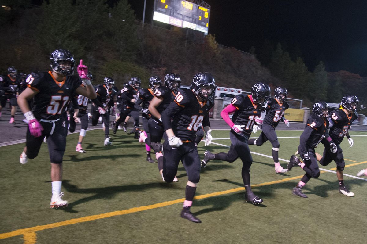 The Lewis and Clark football team takes the field before their game with Gonzaga Prep Friday night at Joe Albi Stadium. (Colin Mulvany / The Spokesman-Review)
