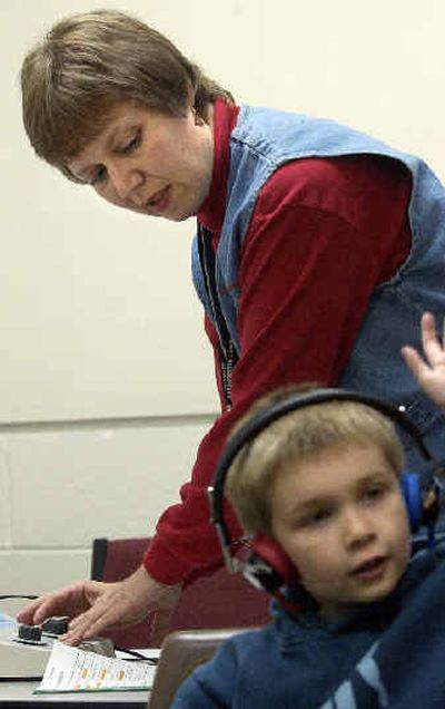 
Central Valley School Nurse Specialist Cheryl Funke administers a hearing exam on Opportunity Elementary kindergartener Logan Babbitt, 5. Funke was recently named Washington State School Nurse of the Year.
 (Liz Kishimoto / The Spokesman-Review)