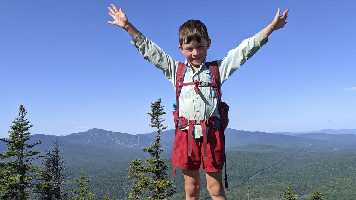 In this July 23, 2021, family photograph provided by Joshua Sutton, 5-year-old Harvey Sutton raises his arms on a mountain top in Bigelow Preserve, Maine, while hiking the Appalachian Trail with parents.  (Joshua Sutton)