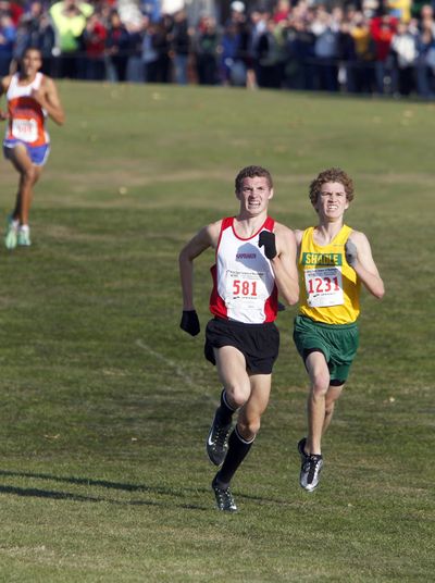 Kamiakin’s Anthony Armstrong, left, passes Shadle Park’s Nathan Weitz during the home stretch of the 3A race.