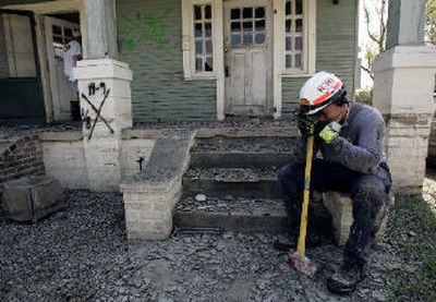 
Florida Task Force 1 member Ray Jadallah takes a break outside a house on Wednesday as his crew searches the Ninth Ward for survivors and corpses after breaking into homes. 
 (The Spokesman-Review)