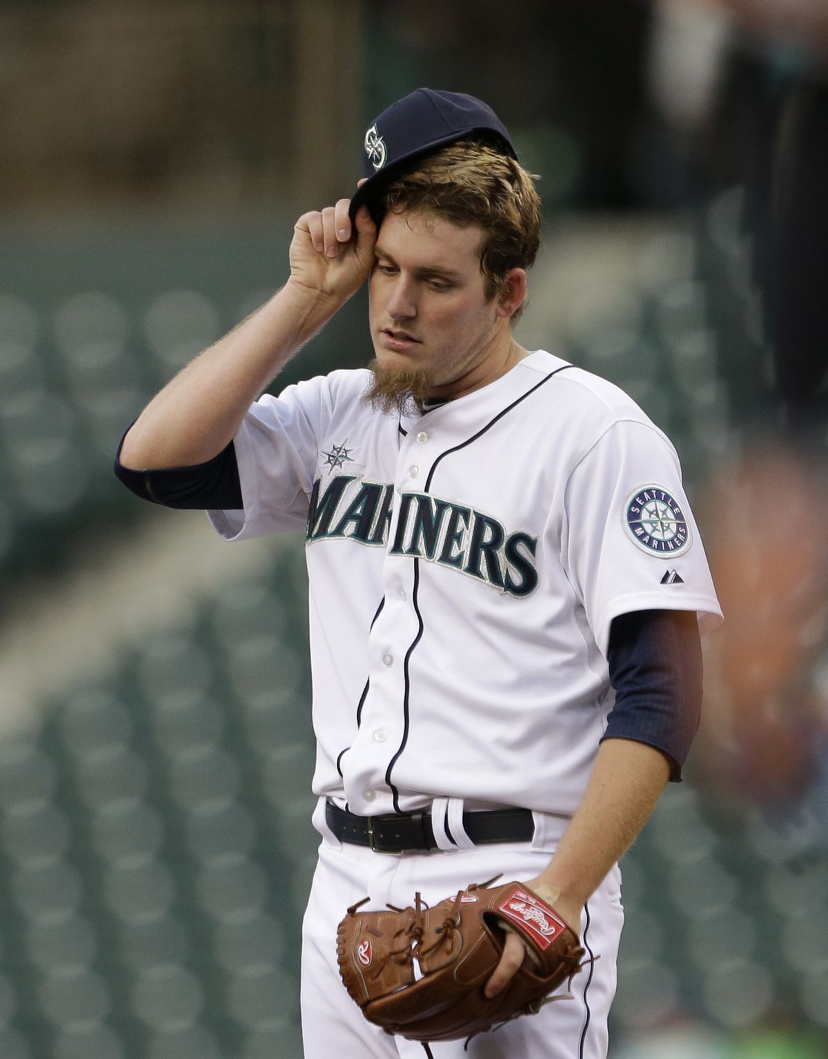 Mariners starter Brandon Maurer adjusts his cap after giving up a first-inning run to the Orioles on Tuesday in Seattle. (Associated Press)