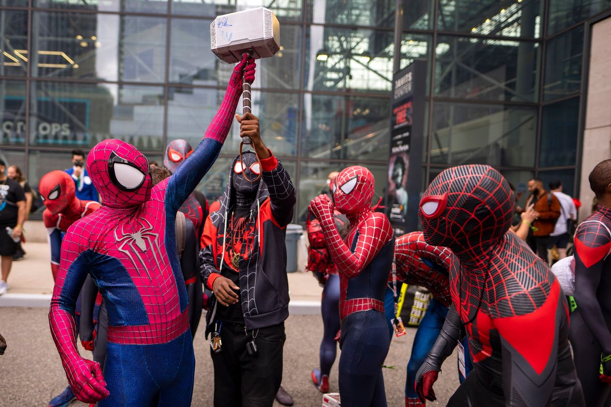 FILE - Attendees dressed as Spider-Man gather during New York Comic Con at the Jacob K. Javits Convention Center on Saturday, Oct. 9, 2021, in New York. After spending one weekend in second place, “Spider-Man: No Way Home” proved it still had some fight left. Sony