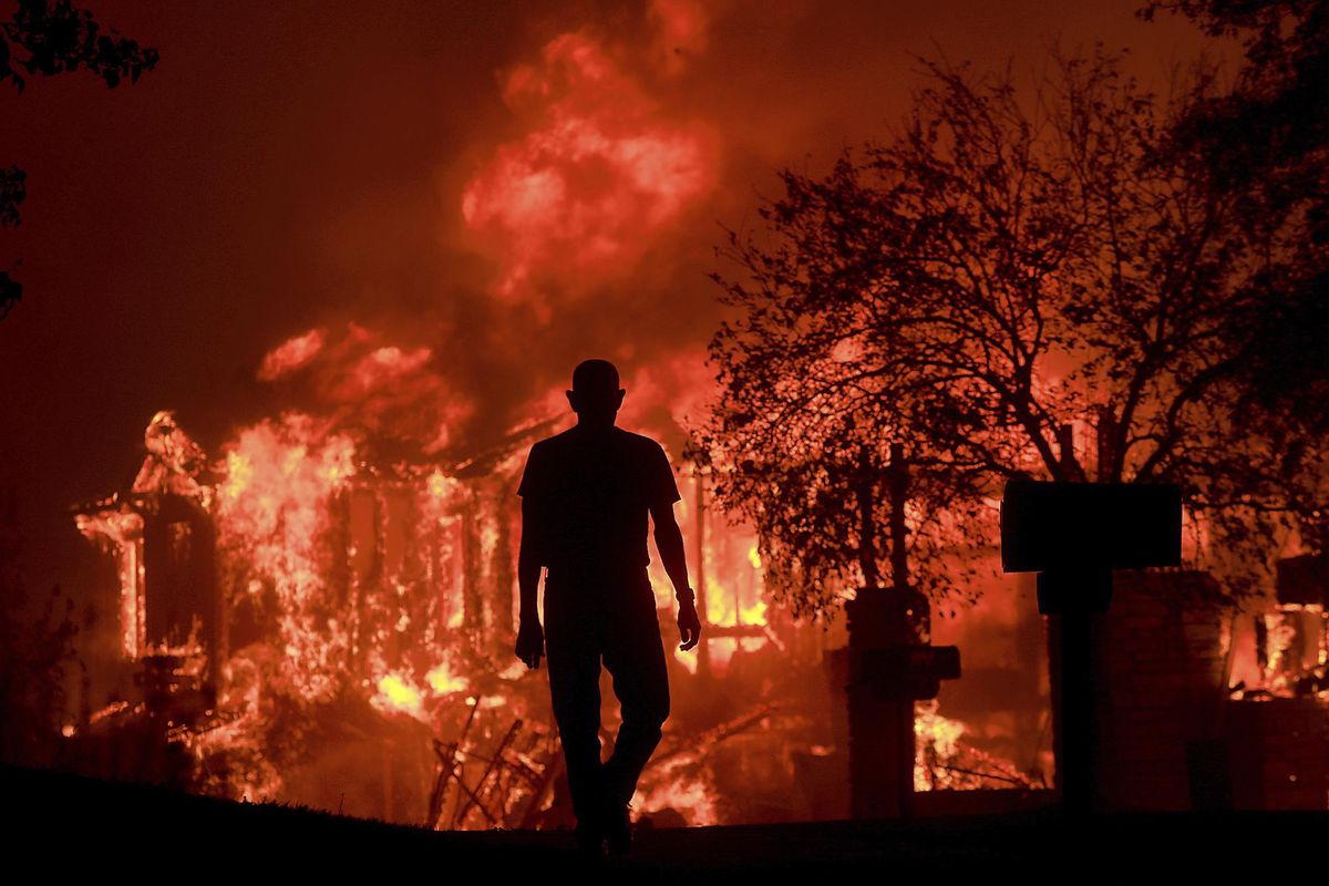 Jim Stites watches part of his neighborhood burn Oct. 9, 2017, in Fountaingrove, Calif. (Kent Porter / The Press Democrat)