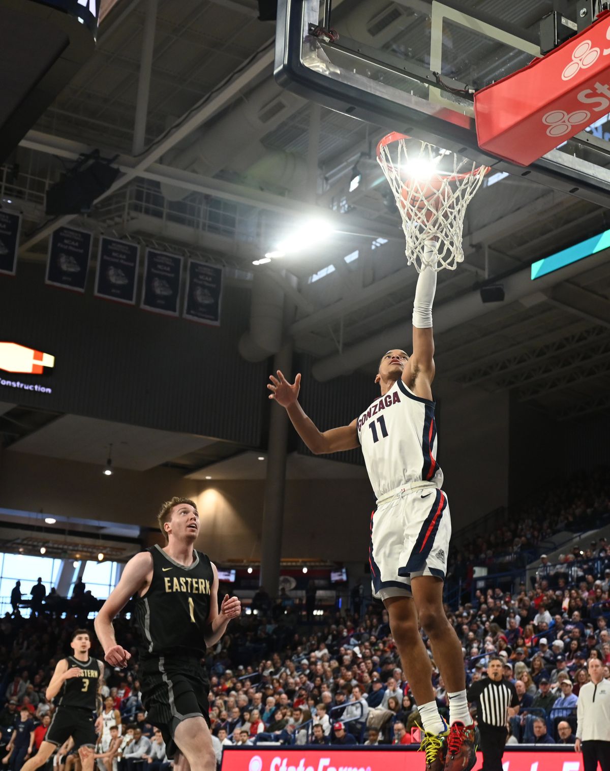 Gonzaga's Nolan Hickman (11) put's up a fastbreak lay-in a step ahead of Eastern Oregon's Slade Dill (1) in the non-conference game between the Eastern Oregon Mountaineers and the Gonzaga Bulldogs in the McCarthey Athletic Center Wednesday, Dec . 28, 2022 at Gonzaga University in Spokane, Washington. The Zags took care of the Mountaineers 120-42. (Jesse Tinsley/THE SPOKESMAN-REVIEW)