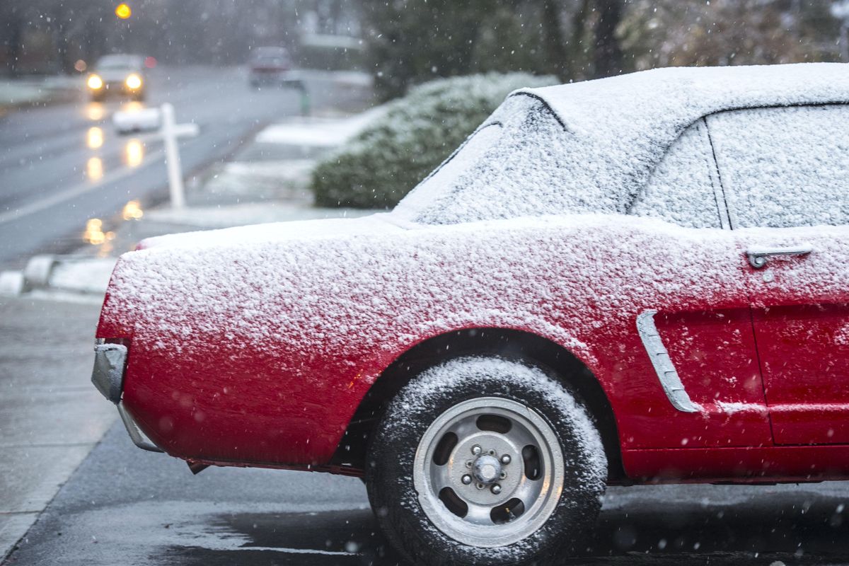 Snow covers a classic Ford Mustang on Hatch Road near 54th Avenue on Wedbesdat in Spokane. (Dan Pelle / The Spokesman-Review)