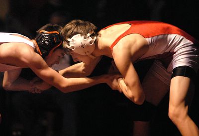 Garret Belgarde, right, of Sandpoint, tangles with Post Falls’ Chad Booth in the 103-pound weight class finals  Dec. 20 during the annual Tri-State wrestling tournament at North Idaho College. Belgarde won by a pin.  (Jesse Tinsley / The Spokesman-Review)