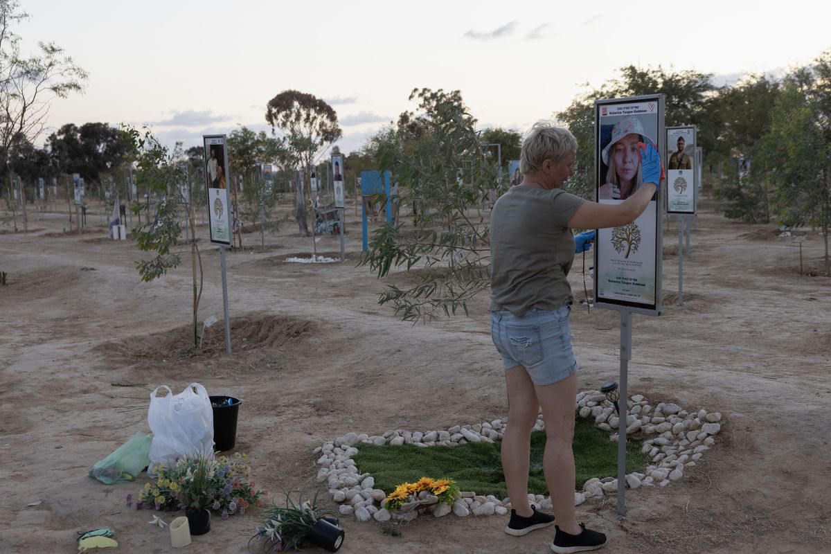 Natalie Tavgen Goldman, 48, cries as she tends to her daughter’s memorial at the Nova Music Festival site in Reim, southern Israel, on the eve of the second anniversary of the Oct. 7, 2023, attacks. (Heidi Levine/For The Washington Post)