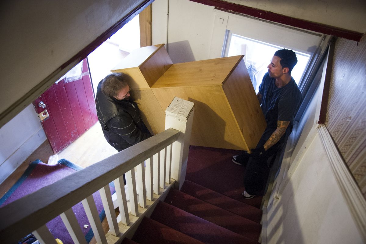 Aaron Gance, left, helps David Natal move out of his Arlin Jordin-owned apartment house on Tuesday. The rental property at 1311 W. Ninth Ave. in Spokane was shut down by the fire department because of unsafe living conditions, leaving many tenants homeless. (Colin Mulvany)