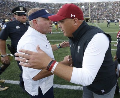 Notre Dame head coach Brian Kelly, left, and Temple head coach Geoff Collins talk after an NCAA college football game between the two schools Saturday, Sept. 2, 2017, in South Bend, Ind. Notre Dame won 49-16. (Charles Rex Arbogast / Associated Press)