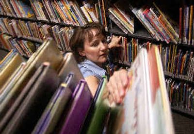 
Jeanne Lancaster restocks the shelves in the children's section of the Valley Library on Monday. The Spokane County Library District released its Spokane Valley Capital Facilities Plan, which calls for a new, larger Valley branch to be built in the next 10 years. 
 (Liz Kishimoto / The Spokesman-Review)