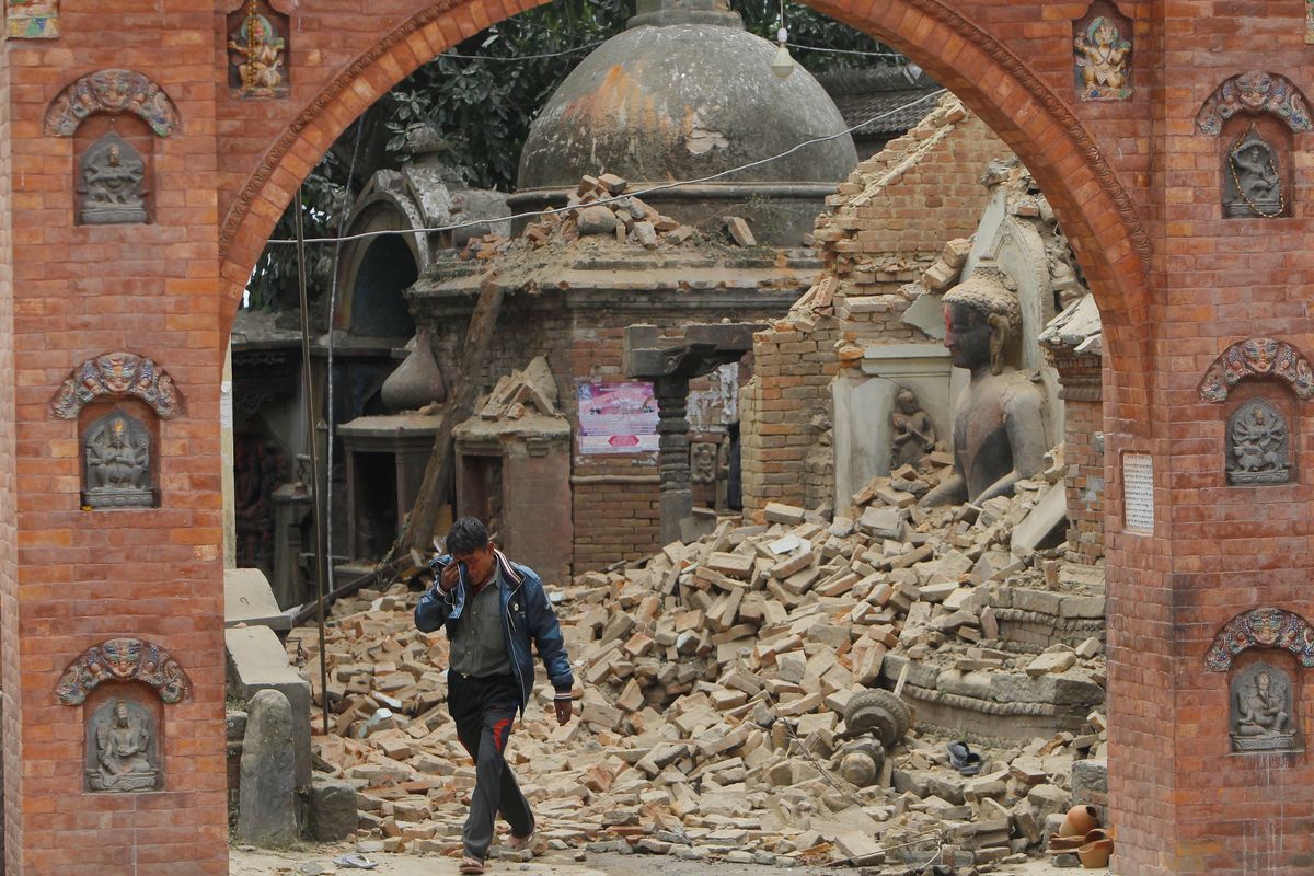 A Nepalese man cries as he walks through the earthquake debris in Bhaktapur, near Kathmandu, Nepal, on Sunday. (Associated Press)