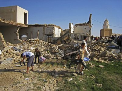 Iraqis inspect a house heavily damaged during an overnight raid by the U.S. military in the town of Adwar, near Samarra, on Friday.  (Associated Press / The Spokesman-Review)