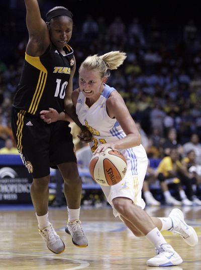 The Sky’s Courtnehy Vandersloot, right, drives on Andrea Riley. (Associated Press)