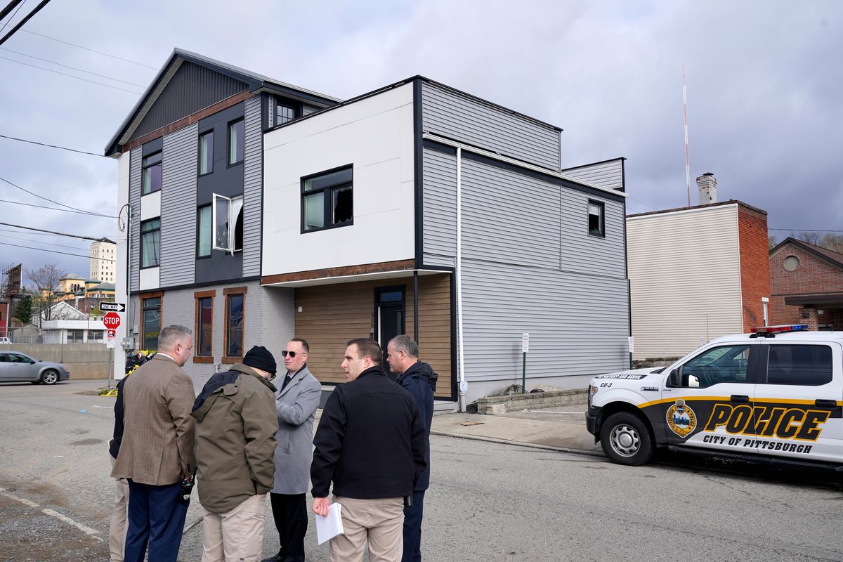 Pittsburgh Police crime scene investigators gather outside the short-term rental property, rear, where a shooting took place at a house party early Sunday morning, April 17, 2022. The shooting happened around 12:30 a.m. during a party at a short-term rental property where there were more than 200 people inside — many of them underage, Pittsburgh police said in a news release.  (Gene J. Puskar)