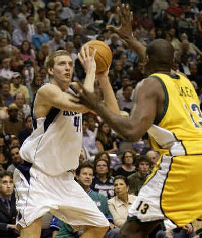 
Dallas' Dirk Nowitzki, left, looks to shoot against Seattle center Jerome James. 
 (Associated Press / The Spokesman-Review)