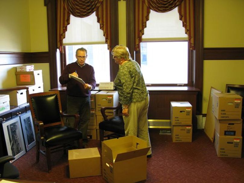 Legislative budget analyst Paul Headlee, left, and legislative budget Director Cathy Holland-Smith, right, work on budget issues amid the boxes at the newly renovated state Capitol on Tuesday. Theirs are among the first offices to move back into the renovated structure, which opens to the public Jan. 9. (Betsy Russell)