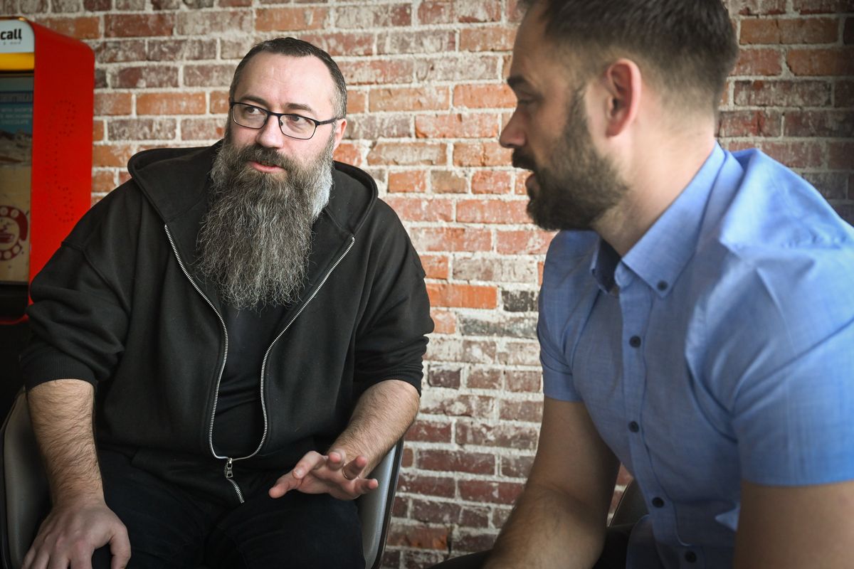 Maksym Bedenko, left, shares the story of his immigration from Ukraine with Boris Borisov, a Spokane pastor from Ukraine who translated an interview with The Spokesman-Review on Friday at a local cafe. Bedenko, who arrived here two years ago, brought his wife and children to find safety from the war with Russia. Now, he said, it would be a great upset to his family if Trump revoked their protected status. (Jesse Tinsley/THE SPOKESMAN-REVIEW)