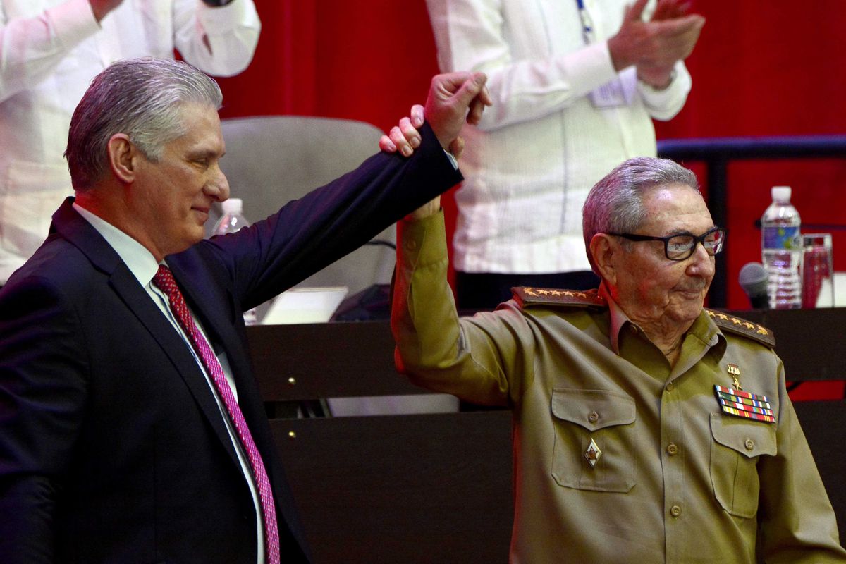 Raul Castro, right, raises the hand of Cuban President Miguel Diaz-Canel after Diaz-Canel was elected First Secretary of the Communist Party at the closing session of Cuban Communist Party