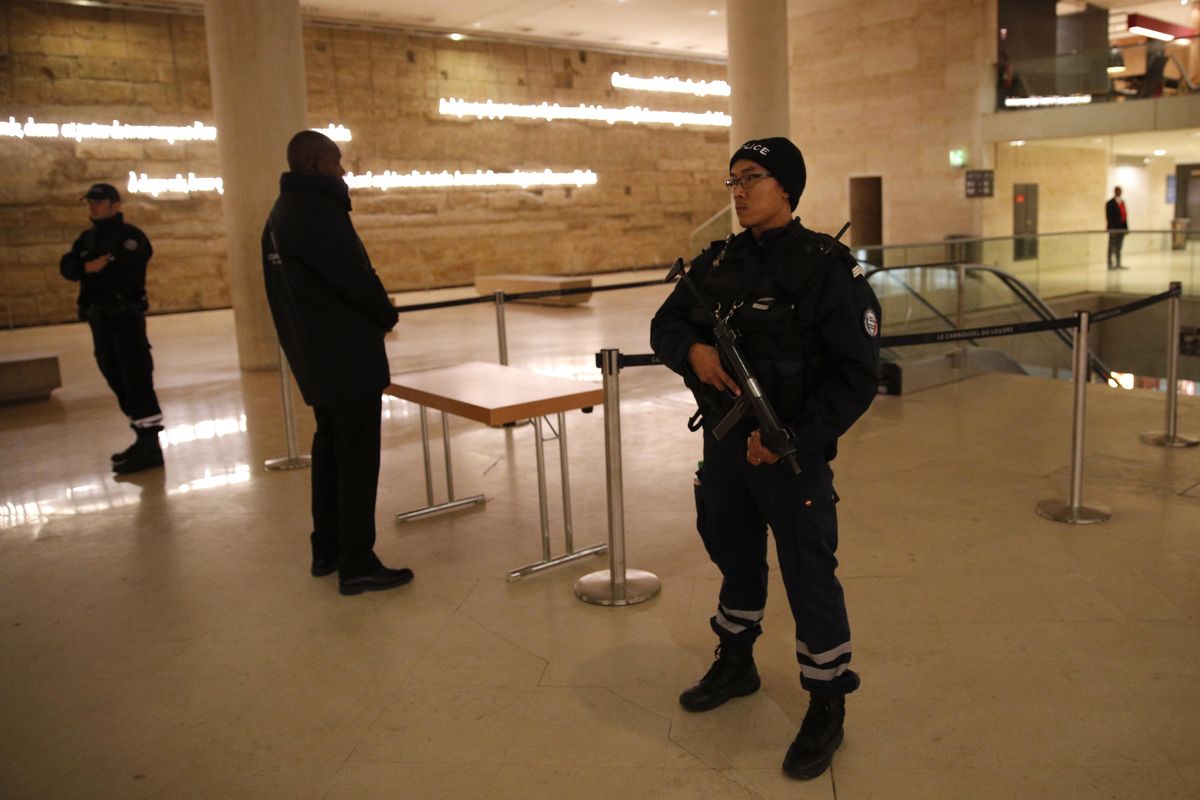 A police officer stands guard inside the Louvre Museum after a shooting outside at the museum in Paris, Friday, Feb. 3, 2017. A knife-wielding man shouting “Allahu akbar” attacked French soldiers on patrol near the Louvre Museum Friday in what the president called a terrorist attack. (Christophe Ena / AP)